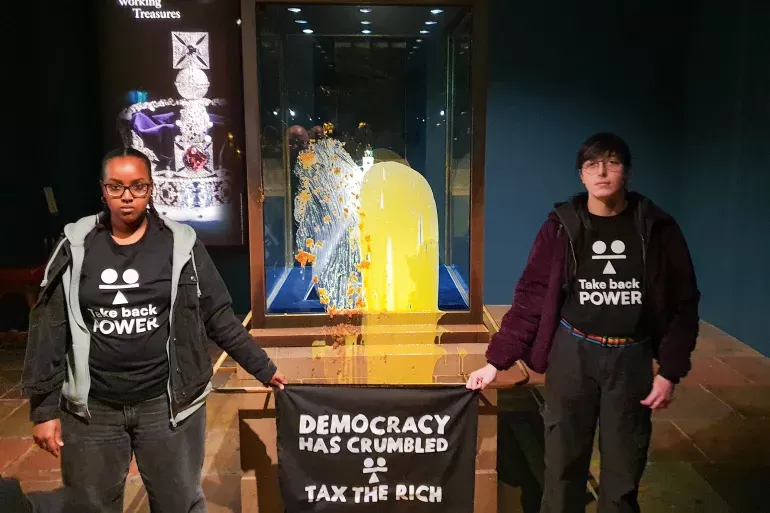 Britain: Four activists arrested after defacing display case of Imperial State Crown with food.